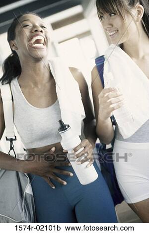 Two young women laughing in a health club View Large Photo Image Stock Image - Two young women laughing in a health club. Fotosearch