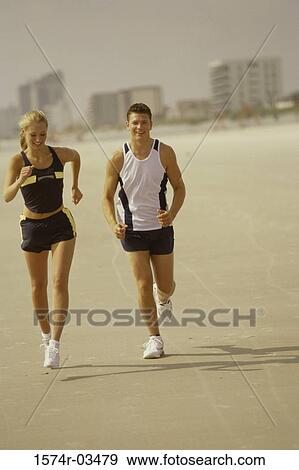 Young couple jogging on the beach View Large Photo Image Stock Photo - Young couple jogging on the beach. Fotosearch