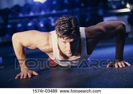 Stock Photo - Young man doing push-ups. Fotosearch