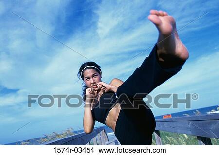 Young woman kickboxing View Large Photo Image Picture - Young woman kickboxing. Fotosearch