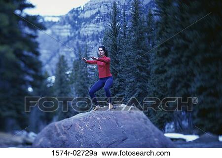 Young woman performing yoga outdoors View Large Photo Image Stock Image - Young woman performing yoga outdoors. Fotosearch