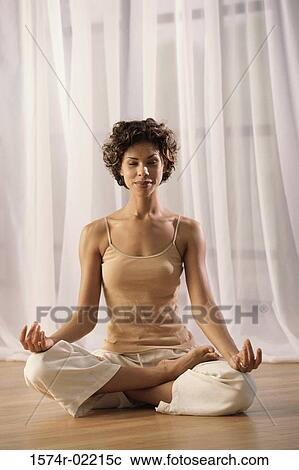 Young woman sitting in the lotus position View Large Photo Image Stock Image - Young woman sitting in the lotus position. Fotosearch