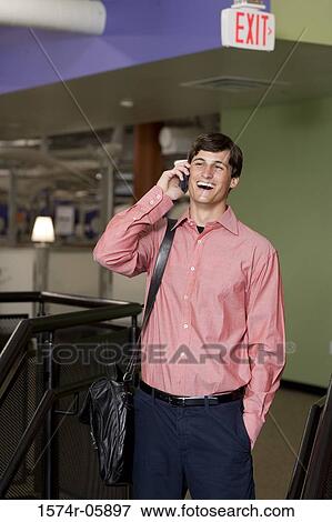 Stock Photo - Businessman talking on a mobile phone. Fotosearch