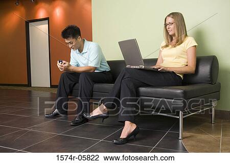 Businesswoman and a businesswoman sitting on a couch View Large Photo Image Stock Image - Businesswoman and a businesswoman sitting on a couch. Fotosearch