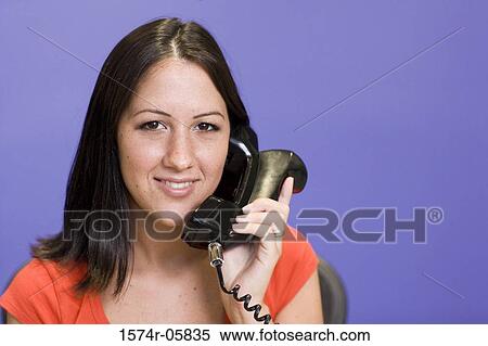 Close-up of a businesswoman talking on a telephone View Large Photo Image Stock Photography - Close-up of a businesswoman talking on a telephone. Fotosearch