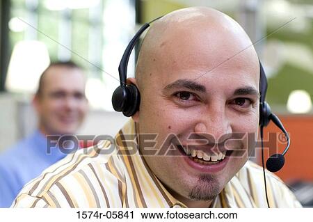 Stock Image - Close-up of a male customer service representative wearing a headset. Fotosearch
