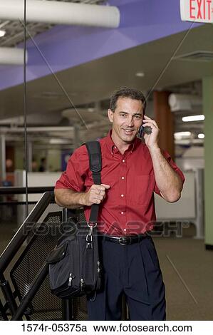 Portrait of a businessman talking on a mobile phone View Large Photo Image Stock Image - Portrait of a businessman talking on a mobile phone. Fotosearch