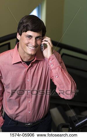 Stock Photograph - Portrait of a businessman talking on a mobile phone. Fotosearch