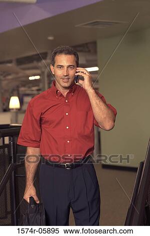 Portrait of a businessman talking on a mobile phone View Large Photo Image Stock Photography - Portrait of a businessman talking on a mobile phone. Fotosearch