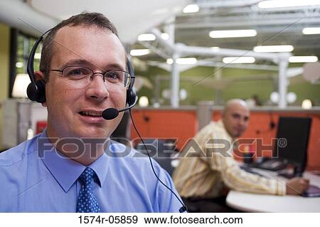 Stock Photo - Portrait of a businessman wearing a headset. Fotosearch