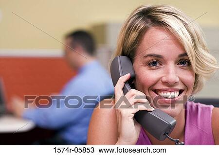 Portrait of a businesswoman sitting in an office talking on a telephone View Large Photo Image Stock Image - Portrait of a businesswoman sitting in an office talking on a telephone. Fotosearch