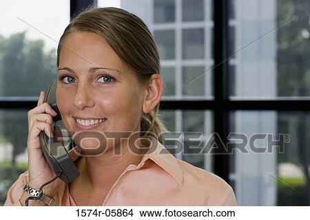 Portrait of a businesswoman talking on a telephone View Large Photo Image Picture - Portrait of a businesswoman talking on a telephone. Fotosearch