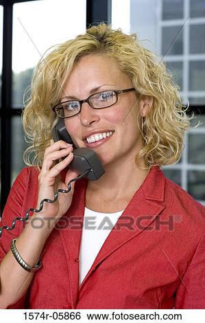 Portrait of a businesswoman talking on a telephone View Large Photo Image Stock Photograph - Portrait of a businesswoman talking on a telephone. Fotosearch