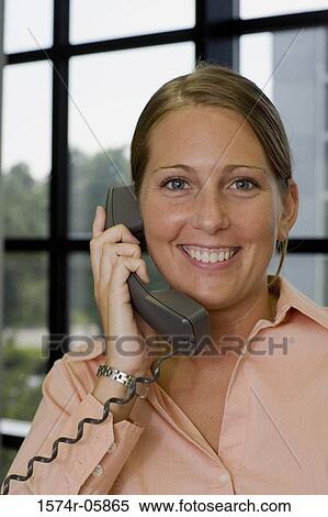 Portrait of a businesswoman talking on a telephone View Large Photo Image Stock Photography - Portrait of a businesswoman talking on a telephone. Fotosearch