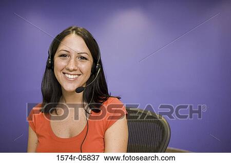 Stock Photo - Portrait of a female customer service representative wearing a headset. Fotosearch