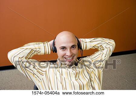 Stock Image - Portrait of a male customer service representative wearing a headset. Fotosearch