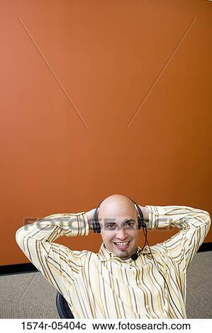 Stock Image - Portrait of a male customer service representative wearing a headset. Fotosearch