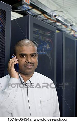 Portrait of a male technician using a mobile phone View Large Photo Image Stock Image - Portrait of a male technician using a mobile phone. Fotosearch