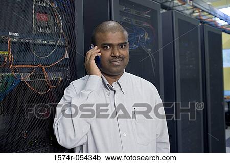 Portrait of a male technician using a mobile phone View Large Photo Image Stock Image - Portrait of a male technician using a mobile phone. Fotosearch