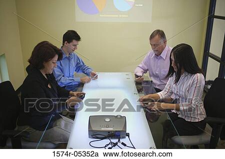 Side profile of a group of business executives sitting in a conference room View Large Photo Image Stock Image - Side profile of a group of business executives sitting in a conference room. Fotosearch