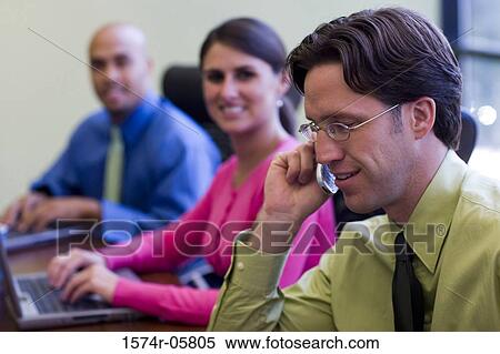 Side profile of two businessmen and a businesswoman sitting in a conference room View Large Photo Image Stock Photography - Side profile of two businessmen and a businesswoman sitting in a conference room. Fotosearch