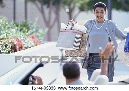 Mature woman carrying shopping bags View Large Photo Image Stock Image - Mature woman carrying shopping bags. Fotosearch