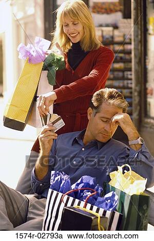 Stock Image - Mid adult man giving a mid adult woman a credit card. Fotosearch