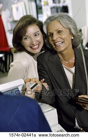 Mother and her daughter shopping in a store View Large Photo Image Stock Image - Mother and her daughter shopping in a store. Fotosearch