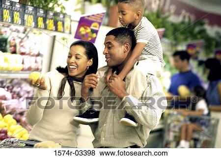 Stock Photo - Parents and their son at a supermarket. Fotosearch