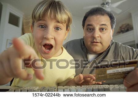 Portrait of a girl and her father in front of a computer View Large Photo Image Stock Image - Portrait of a girl and her father in front of a computer. Fotosearch