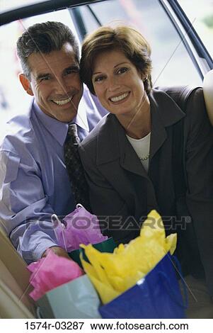 Portrait of a mature couple with shopping bags View Large Photo Image Stock Photo - Portrait of a mature couple with shopping bags. Fotosearch