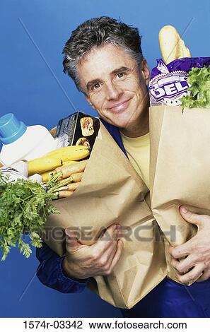 Portrait of a mature man carrying two grocery bags View Large Photo Image Stock Image - Portrait of a mature man carrying two grocery bags. Fotosearch