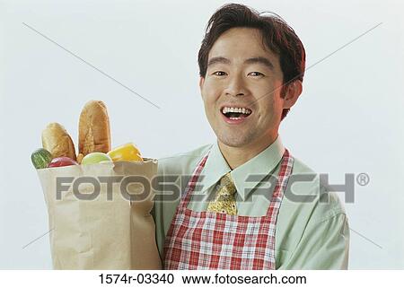Portrait of a young man carrying a grocery bag View Large Photo Image Stock Image - Portrait of a young man carrying a grocery bag. Fotosearch