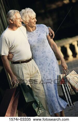 Senior couple carrying shopping bags View Large Photo Image Stock Photography - Senior couple carrying shopping bags. Fotosearch
