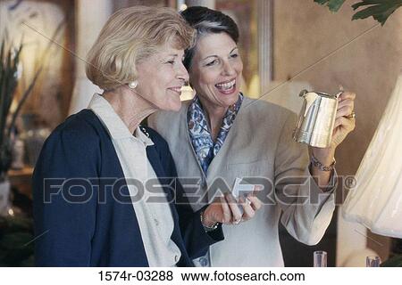 Two mature women shopping in a store View Large Photo Image Stock Photo - Two mature women shopping in a store. Fotosearch