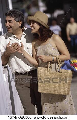 Young couple looking through a store window View Large Photo Image Stock Image - Young couple looking through a store window. Fotosearch