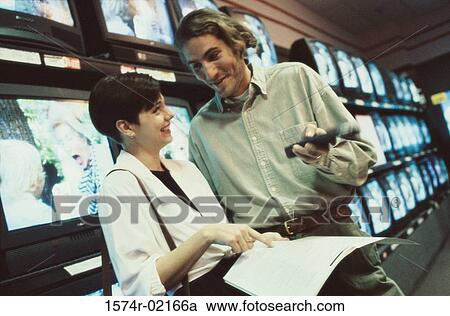 Young couple shopping for a television View Large Photo Image Stock Image - Young couple shopping for a television. Fotosearch
