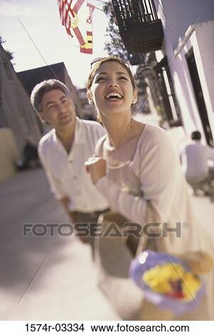 Young couple walking with shopping bags View Large Photo Image Picture - Young couple walking with shopping bags. Fotosearch