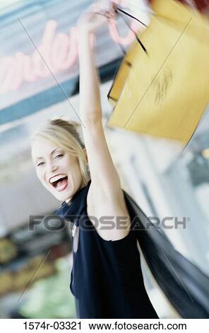 Young woman carrying a shopping bag View Large Photo Image Stock Image - Young woman carrying a shopping bag. Fotosearch