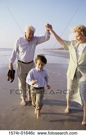 Boy playing on the beach with his grandparents View Large Photo Image Stock Image - Boy playing on the beach with his grandparents. Fotosearch