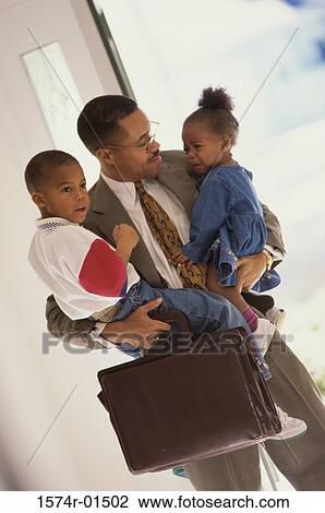 Businessman carrying his son and daughter View Large Photo Image Stock Image - Businessman carrying his son and daughter. Fotosearch
