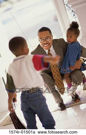 Businessman meeting his son and daughter at the door View Large Photo Image Stock Image - Businessman meeting his son and daughter at the door. Fotosearch