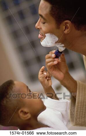 Close-up of a boy watching his father shave View Large Photo Image Stock Photograph - Close-up of a boy watching his father shave. Fotosearch