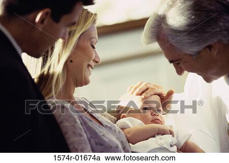 Close-up of a priest blessing a baby View Large Photo Image Stock Image - Close-up of a priest blessing a baby. Fotosearch