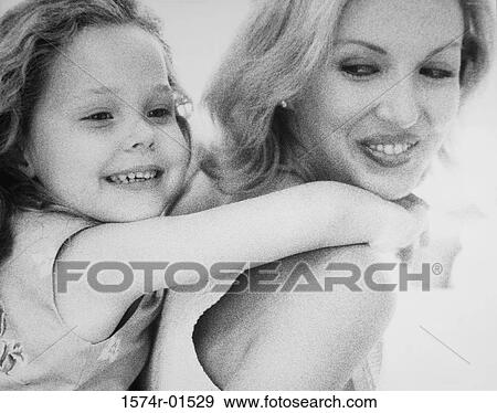 Close-up of a young woman carrying her daughter on her back View Large Photo Image Stock Photo - Close-up of a young woman carrying her daughter on her back. Fotosearch
