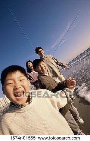 Couple walking with their son at the beach View Large Photo Image Stock Photography - Couple walking with their son at the beach. Fotosearch
