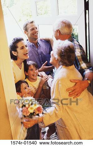 Stock Image - Family greeting each other at the door. Fotosearch