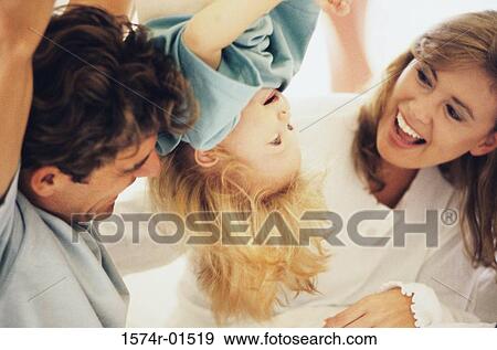 Father and mother playing with their daughter View Large Photo Image Stock Photo - Father and mother playing with their daughter. Fotosearch