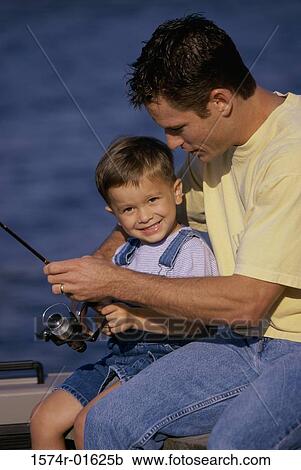 Stock Image - Father and son fishing from a boat. Fotosearch