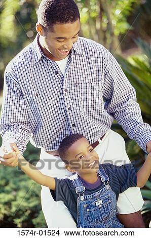 Father and son standing together View Large Photo Image Picture - Father and son standing together. Fotosearch